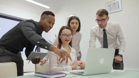Young female trader is presenting to her multiethnical colleagues the results of Stock Footage 85374728