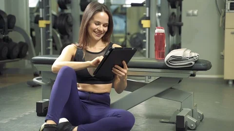 Young female trainer composing an online training program using a tablet pc Stock Footage 123633948