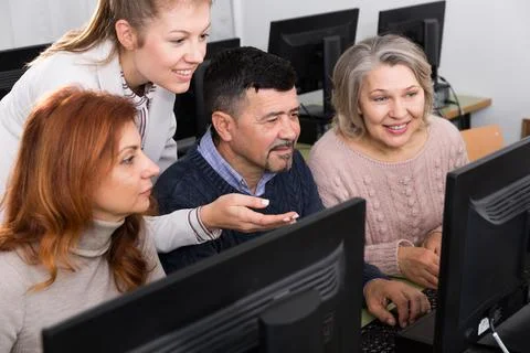 Young female tutor explaining how to use computers 写真素材