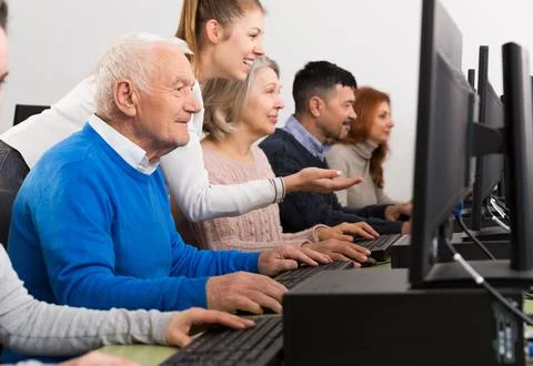Young female tutor explaining how to use computers 写真素材
