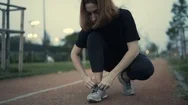 Young Female Tying Her Sport Shoes Before Exercising Stock Footage