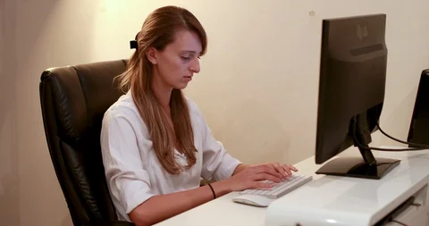 Young female typing on computer in everning Stock Footage 88688959