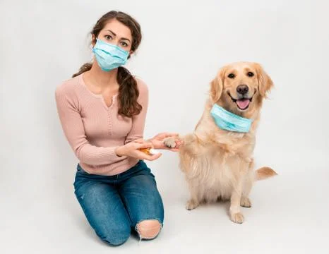 A young female using a face mask as a coronavirus spreading prevention Stock Photos