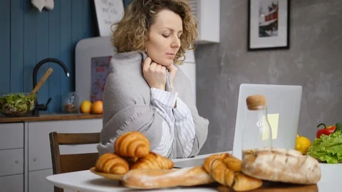 Young Female Using Laptop Computer Sitting In The Kitchen In The Morning. Видео 104587879