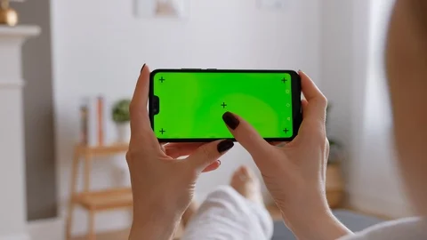 Young Female Using Smart Phone Sitting On Sofa At Home. Stock Footage 128725416