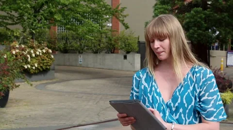 Young female using tablet computer outdoor, summer Stock Footage 52801305