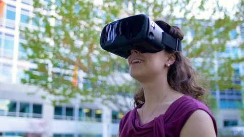 Young Female Using Virtual Reality Glasses Outside Stock Footage 76251342
