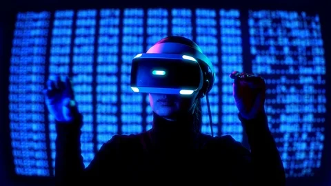 Young female in VR Headset controls virtual reality by hand gestures in front of Stock Footage 87910493