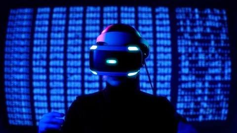 Young female in VR Headset controls virtual reality by hand gestures in front of Stock Footage 87910621