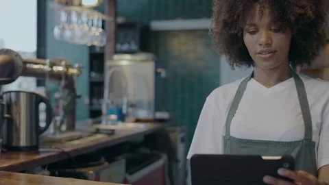 Young female waitress checking orders on the tablet Stock Footage 285321516