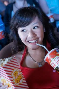 Young Female Watching Movie In Theater Stock Photos