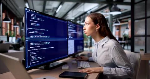Young Female Web Developer Feels Frustrated And Bored While Coding Alone. Stock Photos