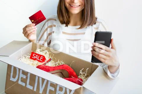 Young female woman adult customer buyer smiling received purchased new red hi Stock Photos