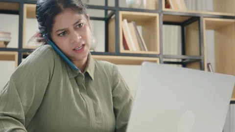 A young female worker stressed while multitasking in a modern start up business  Stock Footage 295412342