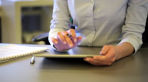 Young female working on digital tablet in office, looking camera smiling Stock Footage 43149690