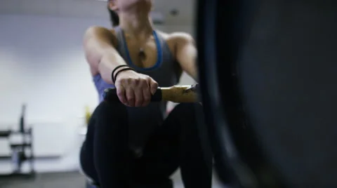 Young female working out on a rowing machine at the gym Stock Footage 59861835