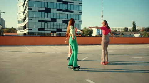 Young females performing dance elements on roller skates Stock Footage 253994686