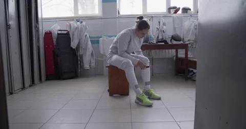 Young fencer adjusting socks before training Stock Footage 224965545