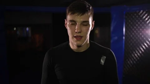 Young fighter he is looking at the camera and gets ready for battle Video stock 71664636