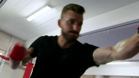 Young fighter practicing punching on a punching bag 4K. Stock Footage 234573916