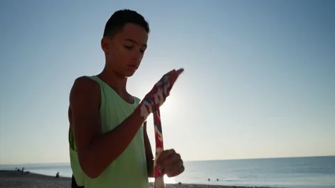 Young fighter wraps her hands with boxing bandages, kickboxing training outdoor Video stock 210719519