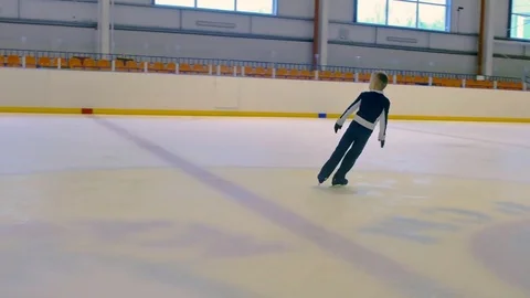 Young Figure Skater Performs a Jump Stock Footage 69999608