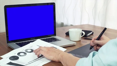 Young finance analyst working with printed analyzing graphs using digital tablet Stock Footage 81879529