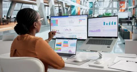 Young Financial Analyst Studies Data On Laptop To Improve Business Profits. Stock Photos