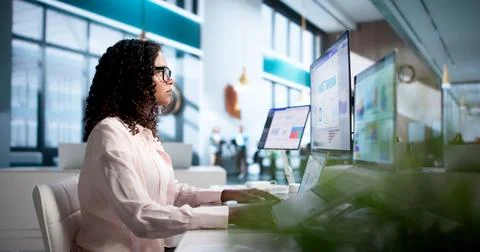 Young Financial Analyst Studying Dashboard Data On Laptop And Desktop Screens Stock Photos