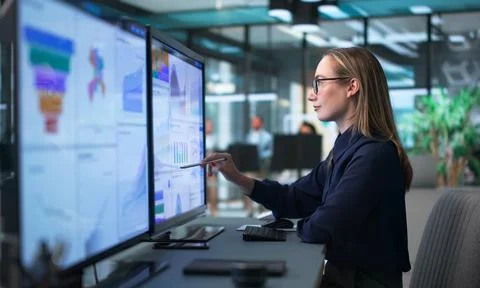 Young Financial Analyst Using Computer To Review Market Data Insights. Stock Photos