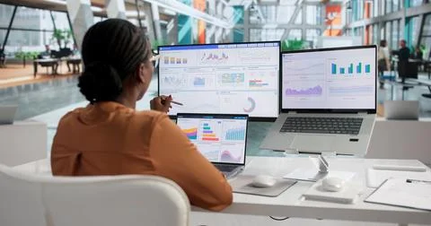Young Financial Analyst Using Laptop To Review Business Data Dashboard Insigh Stock Photos