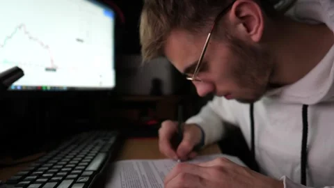 Young financial analyst working with commodities and foreign exchange charts Stock-Footage 306741150