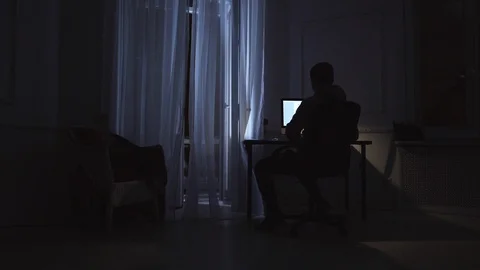 Young finish work on script on computer at night room, cat on window sill Stock Footage 85707881