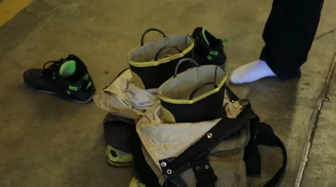 Young fireman getting geared up in his fire man uniform Stock Footage 66549109