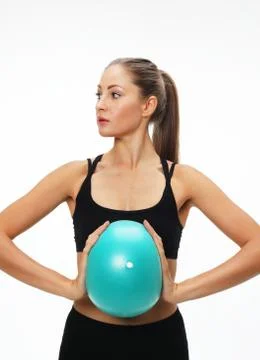 Little girl doing gymnastics with hoop, ball and split isolated on