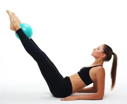 Little girl doing gymnastics with hoop, ball and split isolated on