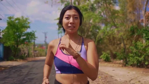 Young fit and active runner woman running and jogging at countryside road Stock Footage 131803407