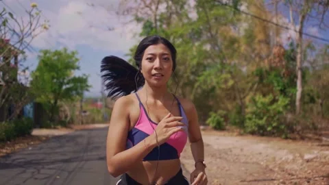 Young fit and active runner exotic woman running and jogging at countryside road Stock Footage 131803462