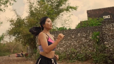 Young fit and active runner woman running and jogging at countryside road Stock Footage 131803515