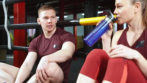 Young fit couple talking during the break in gym Stock Footage 102459577
