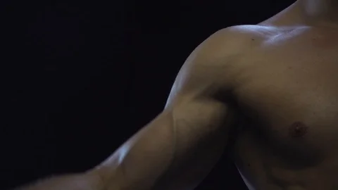 Young fit guy shows biceps, loop Stock Footage 108950686