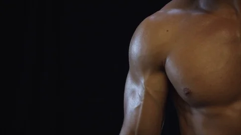 Young fit guy shows biceps Stock Footage 109499318