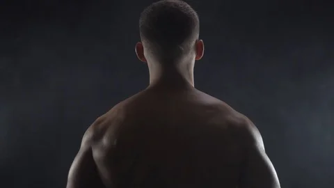 Young fit guy shows double biceps, silhouette 스톡 동영상 109498978