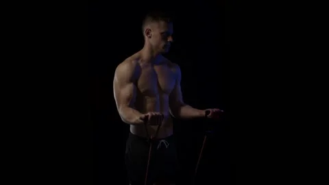 Young fit man on black background. Loop Stock Footage 137211436