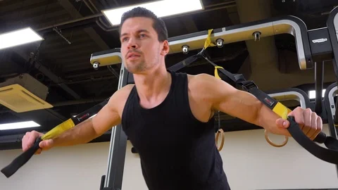 A young fit man does inclined push-ups in a gym - closeup from below Stock Footage 87929490