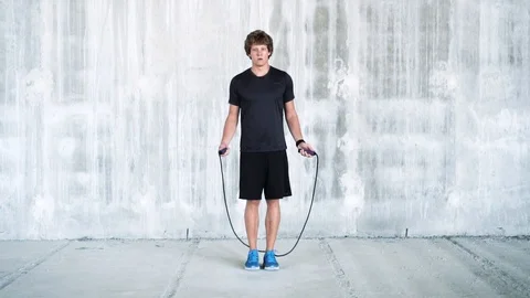 Young fit man doing jump rope workout. Stock Footage 112654292