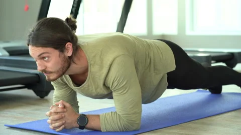 Young fit man doing plank exercise in fitness gym healthy lifestyle concept. Stock Footage 146320901
