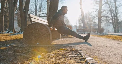 Young fit man doing triceps dips exercises during training workout Video stock 146554267