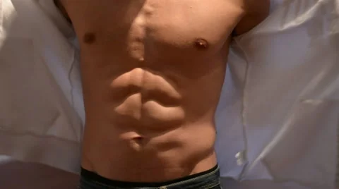 Young fit man opening sweater on naked muscular torso Stock Footage 60398829