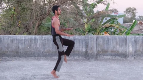 Young Fit Man Performing High Knees Cardio Exercise on Rooftop Видео 330390392